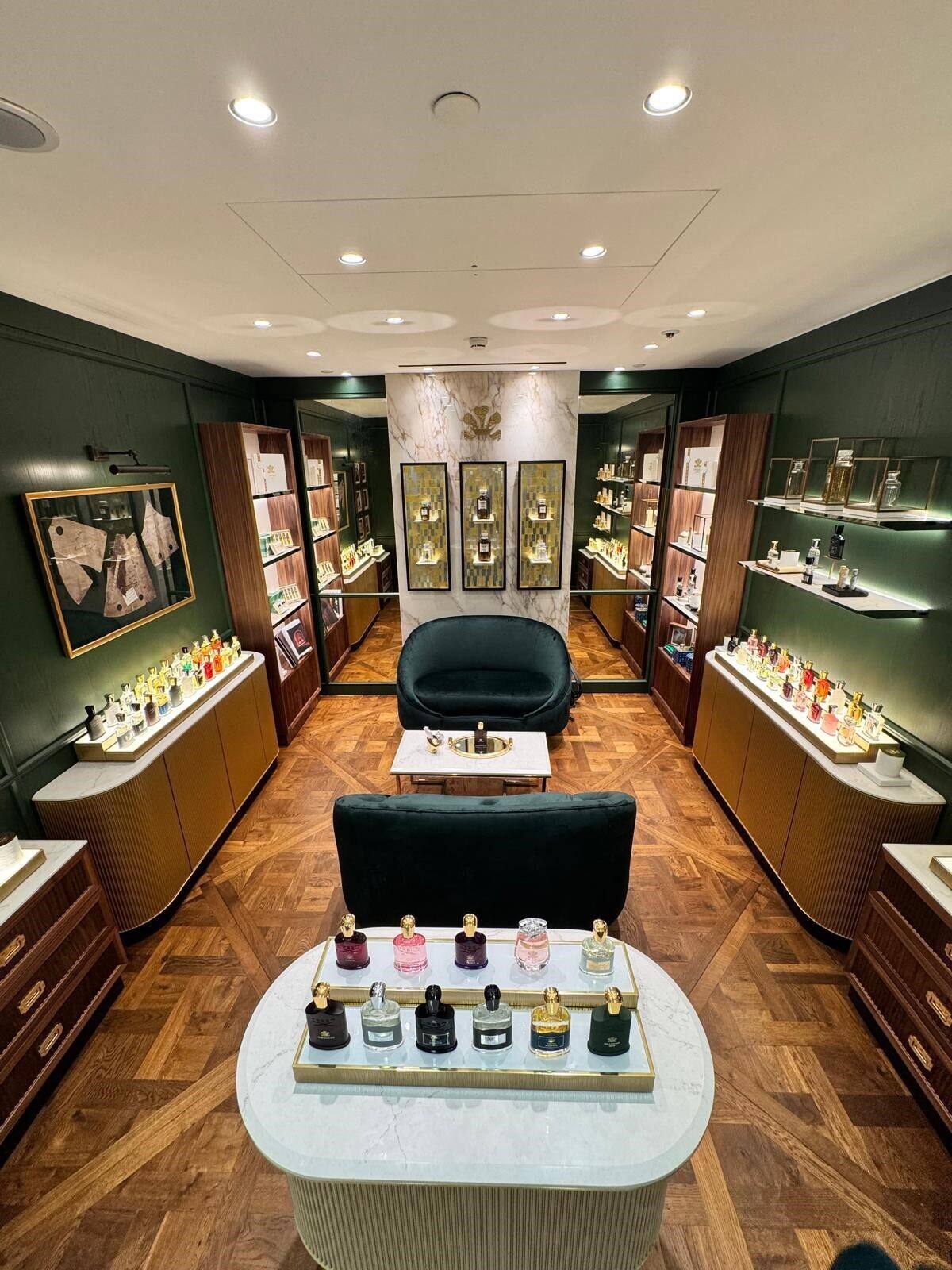 Luxury perfumery boutique interior with walnut cabinetry