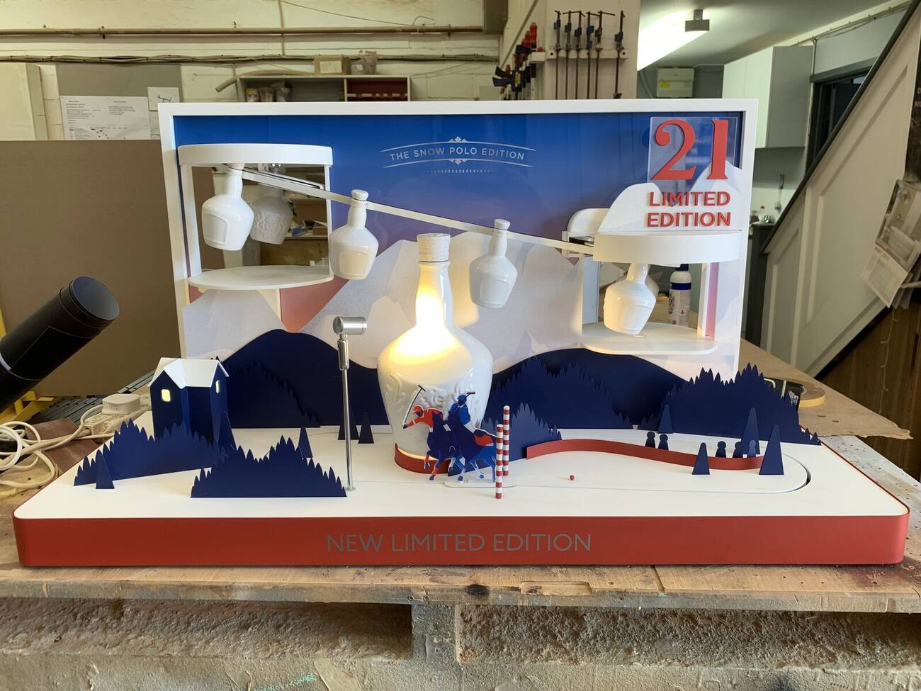 Miniature winter scene glorifier display unit for a limited edition bottle