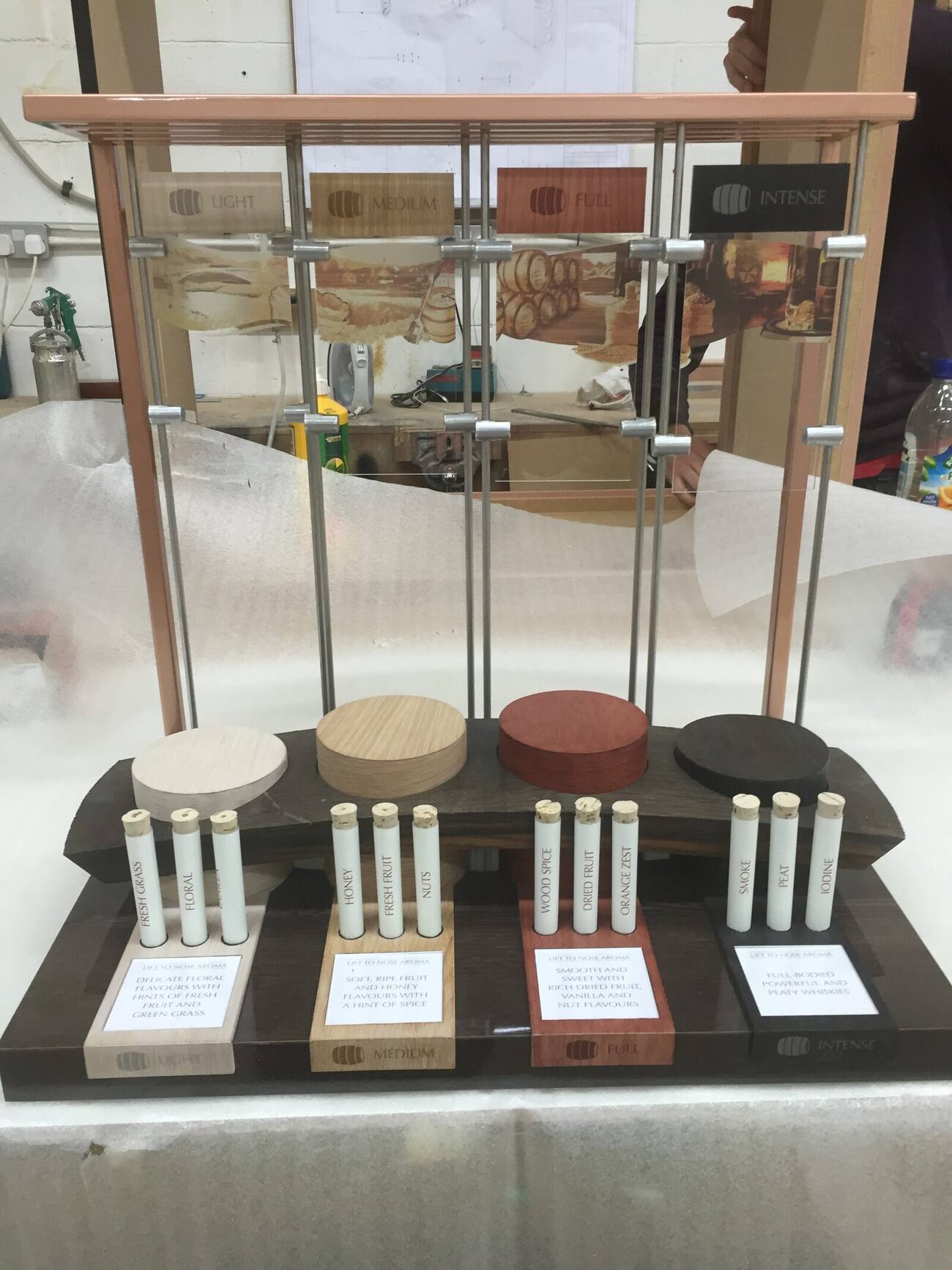 Detailed point of sale tasting unit with suspended miniature bottles