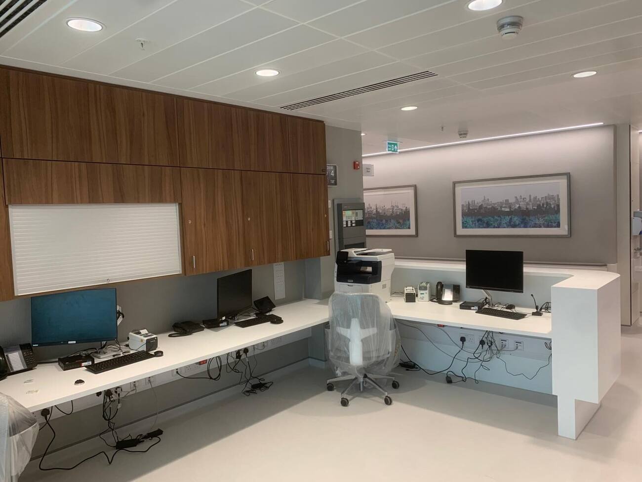 Fitted walnut cabinetry in a clinical staff area