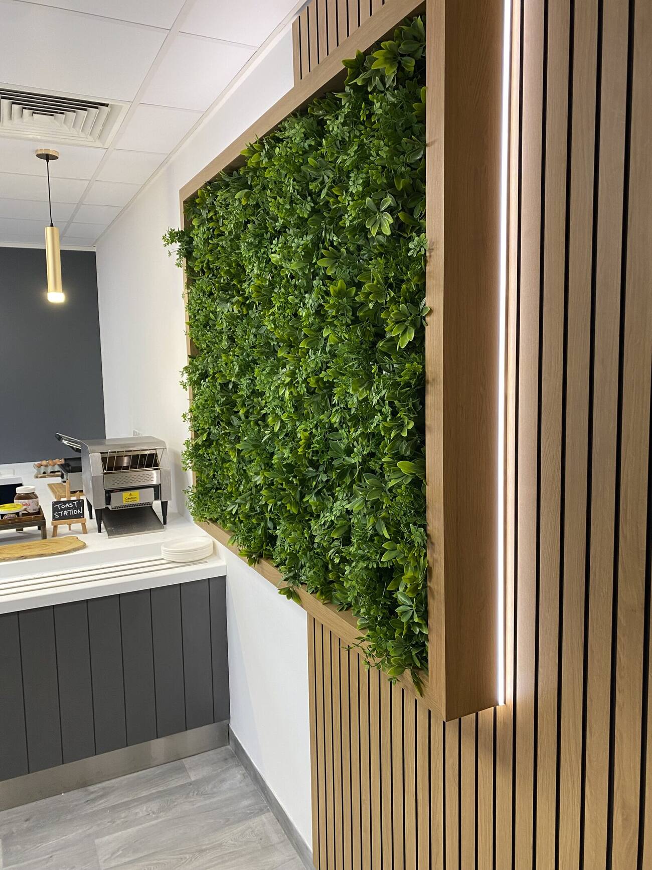 Preserved moss feature wall set into timber slatted ceiling detail