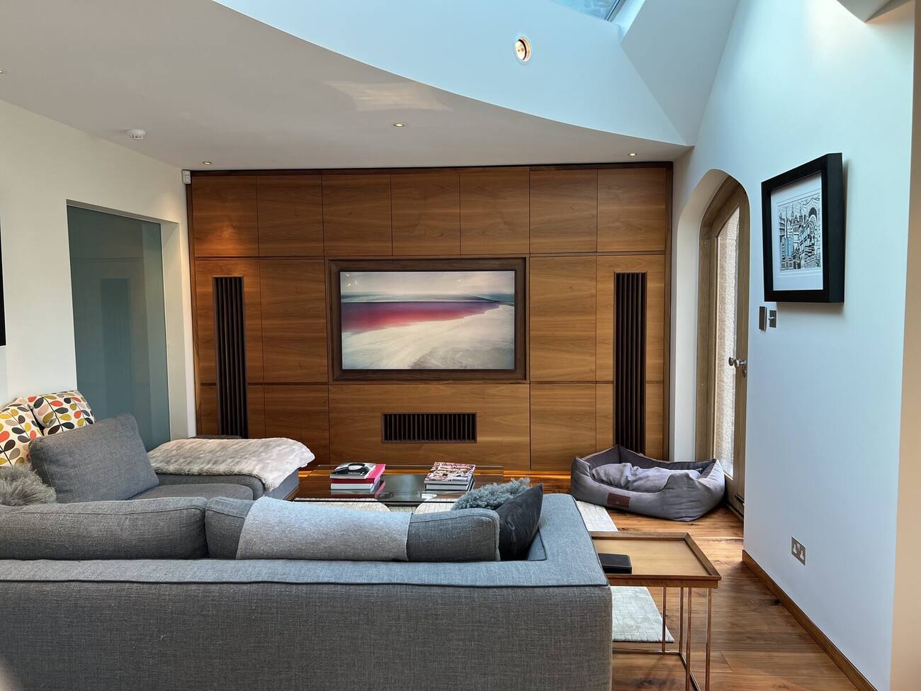 Bespoke timber media wall with fitted cabinetry in a residential living room