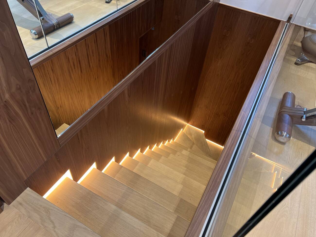 Walnut staircase with lighting detail