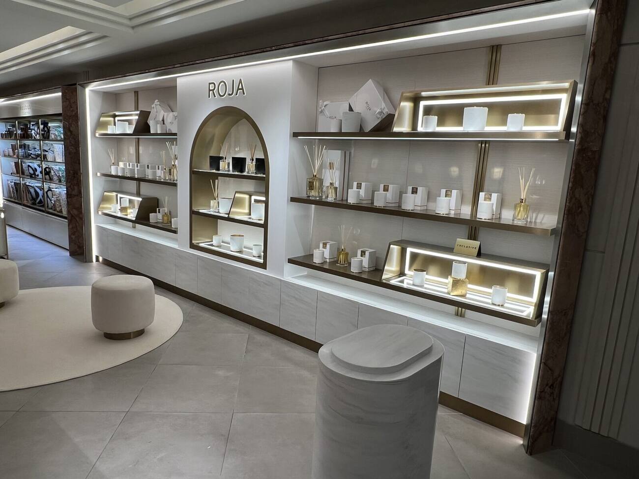 Bespoke perfumery display counter with illuminated shelving in a department store